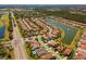 Aerial view of planned community with well-kept landscaping, lakes, and a highway nearby at 10829 Royal Cypress Way, Orlando, FL 32836