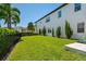 Large grassy backyard surrounded by lush greenery and a sleek black fence at 10829 Royal Cypress Way, Orlando, FL 32836