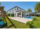 Spacious backyard with a pool, covered patio, and basketball hoop at 10829 Royal Cypress Way, Orlando, FL 32836