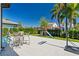 Expansive backyard featuring a basketball hoop and playset perfect for Gathering activities at 10829 Royal Cypress Way, Orlando, FL 32836