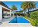 Serene backyard featuring a sparkling pool, pergola, and well-manicured landscaping, perfect for outdoor enjoyment at 10829 Royal Cypress Way, Orlando, FL 32836
