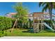 Backyard featuring a play set and lush green grass at 10829 Royal Cypress Way, Orlando, FL 32836