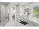 Bright bathroom with double vanity, separate shower, and garden tub at 10829 Royal Cypress Way, Orlando, FL 32836