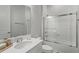 Modern white bathroom featuring a glass shower, white vanity, and elegant fixtures at 10829 Royal Cypress Way, Orlando, FL 32836