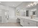 Bright bathroom with white tile, a glass-enclosed shower, a soaking tub, and double vanity sinks at 10829 Royal Cypress Way, Orlando, FL 32836