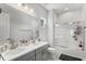 Well-lit bathroom with double sinks, modern fixtures, and a shower-tub combo at 10829 Royal Cypress Way, Orlando, FL 32836