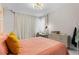 Cozy bedroom with modern light fixture, sleek desk, and bright natural light at 10829 Royal Cypress Way, Orlando, FL 32836