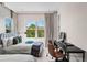 Bedroom features two twin beds, large windows, and a comfortable workspace, offering a serene retreat at 10829 Royal Cypress Way, Orlando, FL 32836