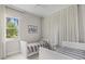 Bright bedroom with two twin beds, large window and white trim provides a cozy atmosphere at 10829 Royal Cypress Way, Orlando, FL 32836