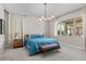 Bright bedroom with plush carpet, stylish lighting, and a beautiful window view of the backyard at 10829 Royal Cypress Way, Orlando, FL 32836