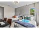 Bedroom showcasing two stylish beds, natural light, and a dedicated workspace with desk and chair at 10829 Royal Cypress Way, Orlando, FL 32836