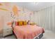 Bright bedroom featuring an eye-catching accent wall and a comfortable bed with stylish accents at 10829 Royal Cypress Way, Orlando, FL 32836