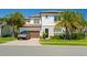 Charming two-story home with a well-manicured lawn and a Tesla Cybertruck parked out front at 10829 Royal Cypress Way, Orlando, FL 32836