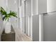 Modern hallway with wood floors, custom paneling, and accent lighting is sleek and inviting at 10829 Royal Cypress Way, Orlando, FL 32836