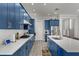 Spacious kitchen with blue cabinetry, stainless steel appliances, ample counter space, and hardwood flooring at 10829 Royal Cypress Way, Orlando, FL 32836