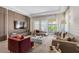 Modern living room featuring stylish furniture, a large window, and contemporary decor at 10829 Royal Cypress Way, Orlando, FL 32836