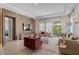 Bright living room featuring modern furniture, a large window with outdoor views, and stylish decor at 10829 Royal Cypress Way, Orlando, FL 32836