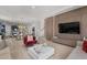 Spacious living room with modern wood wall feature, large windows, and an open concept layout at 10829 Royal Cypress Way, Orlando, FL 32836