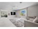 Bright living room features large windows, neutral decor, and plush rug at 10829 Royal Cypress Way, Orlando, FL 32836