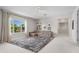 Spacious living area with oversized rug, neutral tones, and bright natural light at 10829 Royal Cypress Way, Orlando, FL 32836