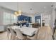 Expansive open floor plan showcasing a modern kitchen with blue cabinetry and stainless steel appliances at 10829 Royal Cypress Way, Orlando, FL 32836