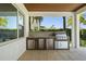 Outdoor kitchen features modern stainless steel grill and sink area at 10829 Royal Cypress Way, Orlando, FL 32836