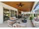 Covered patio with plenty of seating and a view of the backyard at 10829 Royal Cypress Way, Orlando, FL 32836