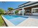 Beautiful pool and backyard area with a covered patio and outdoor dining, perfect for entertaining at 10829 Royal Cypress Way, Orlando, FL 32836