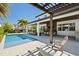 Backyard with a pool, patio, and outdoor seating under a pergola at 10829 Royal Cypress Way, Orlando, FL 32836