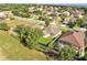 Overhead view of homes in a neighborhood, set amidst expansive green spaces and mature trees at 10955 Lemay Dr, Clermont, FL 34711