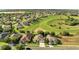Aerial view showcasing homes adjacent to a spacious greenbelt, offering privacy and scenic views at 10955 Lemay Dr, Clermont, FL 34711