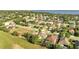 Aerial view of a residential community featuring single-Gathering homes near a lake, blending neighborhood and nature at 10955 Lemay Dr, Clermont, FL 34711