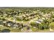 Expansive aerial view of a neighborhood showcasing well-maintained homes and lush green landscaping at 10955 Lemay Dr, Clermont, FL 34711