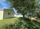 The backyard features a lush lawn with mature trees along the fence at 10955 Lemay Dr, Clermont, FL 34711
