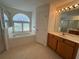 Bathroom featuring a soaking tub, glass enclosed shower and double vanity at 10955 Lemay Dr, Clermont, FL 34711