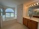 Bathroom with garden tub, shower, and tiled floors at 10955 Lemay Dr, Clermont, FL 34711