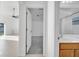 View from the bathroom into the bedroom, featuring carpeted floors and a ceiling fan at 10955 Lemay Dr, Clermont, FL 34711
