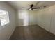Bedroom with carpeted floors, a ceiling fan, and a window with shutters at 10955 Lemay Dr, Clermont, FL 34711