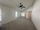 Spacious carpeted bedroom with vaulted ceiling and multiple windows at 10955 Lemay Dr, Clermont, FL 34711
