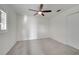 Bedroom with neutral carpet, ceiling fan, and window with plantation shutters at 10955 Lemay Dr, Clermont, FL 34711