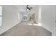 Bright bedroom features vaulted ceiling, neutral carpet and sliding glass door to outside at 10955 Lemay Dr, Clermont, FL 34711