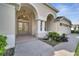 Inviting entrance with double doors, decorative columns, and well-maintained landscaping at 10955 Lemay Dr, Clermont, FL 34711