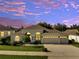 Charming single-story home with manicured lawn, three-car garage, and beautiful landscaping at dusk at 10955 Lemay Dr, Clermont, FL 34711