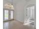 Inviting foyer with tile flooring and glass paneled front door at 10955 Lemay Dr, Clermont, FL 34711