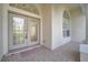 Elegant double front doors with decorative glass, sheltered entrance, and tiled porch at 10955 Lemay Dr, Clermont, FL 34711