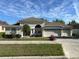 Charming single-story home with a three-car garage and well-manicured landscaping at 10955 Lemay Dr, Clermont, FL 34711