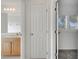 Hallway with a linen closet in view of the bathroom with vanity and open door to a bedroom at 10955 Lemay Dr, Clermont, FL 34711