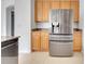 Kitchen featuring stainless steel refrigerator and wooden cabinetry at 10955 Lemay Dr, Clermont, FL 34711