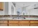 Kitchen sink and granite countertops with wood cabinetry at 10955 Lemay Dr, Clermont, FL 34711