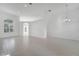 Bright, airy living room featuring tile flooring, chandelier, and large arched window at 10955 Lemay Dr, Clermont, FL 34711